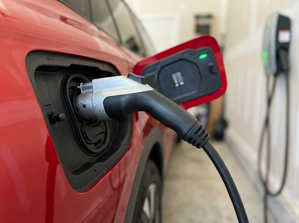 Close-up of J1772 connector plugged into a Volkswagen ID.4 charge port